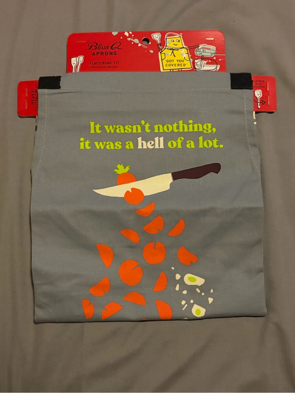 Blue Q Gray Apron with Orange Veggie Graphic and Yellow Text